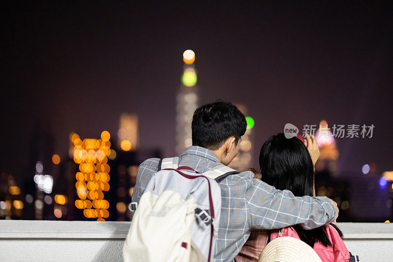 couple backpacker with night city